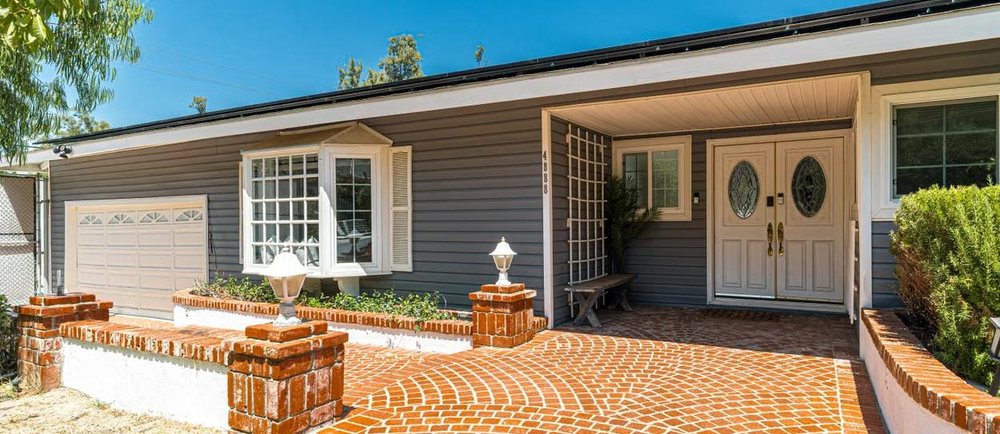 Renovated single-family home with a brick paver entry